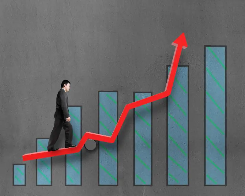 Businessman walking on growth red arrow with chart