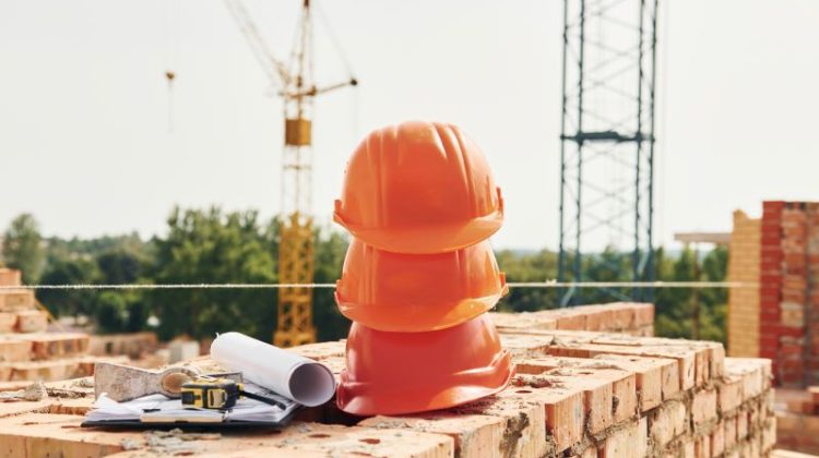Close up view of protective hard hats that laying down on the bricks