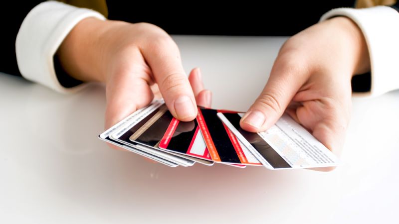 Closeup image of female hands holding lots of credit card