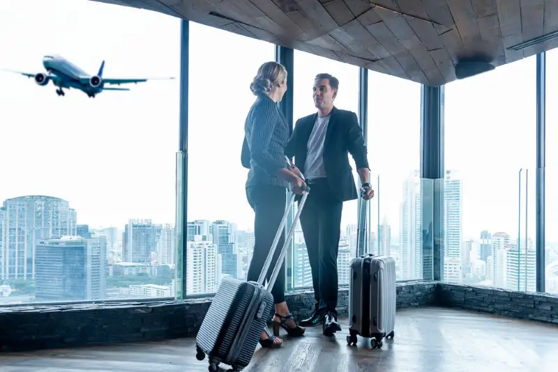 Business women and businessmen leave luggage