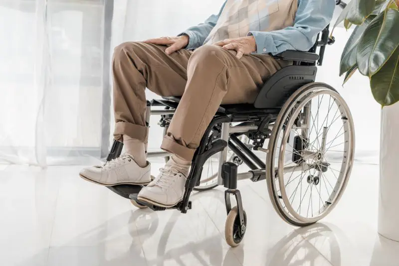Close up of senior man sitting in wheelchair in nursing home