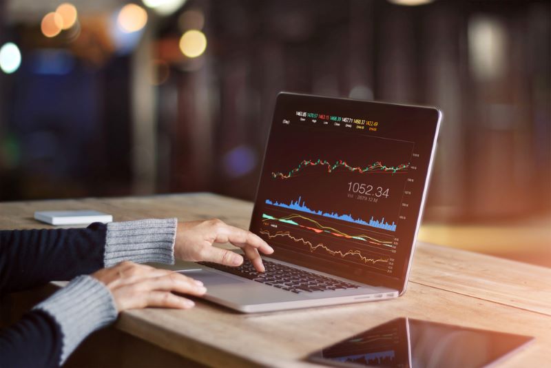 Businessman using laptop for analyzing data stock market