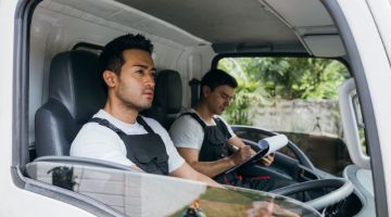 Mover workers transporting items in a commercial vehicle