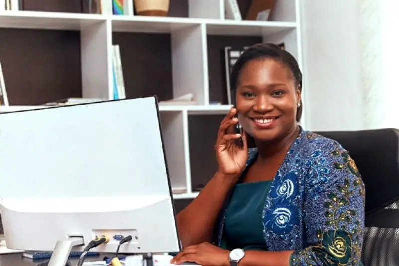 Woman on the phone sitting at a desk in the office