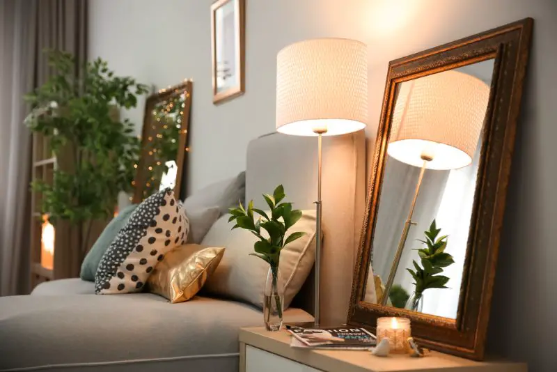 Elegant room interior with mirror on nightstand