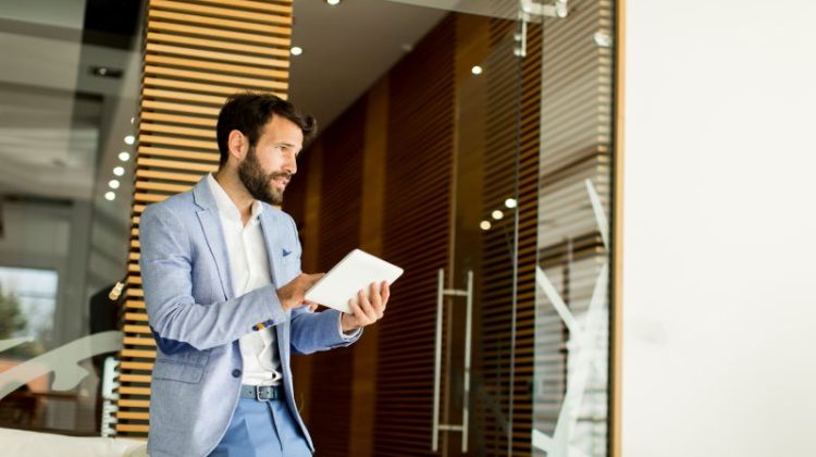 Property manager with tablet standing in the office