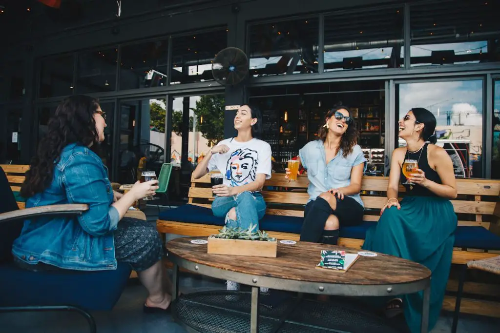 group of female friends networking - having a drink and a laugh
