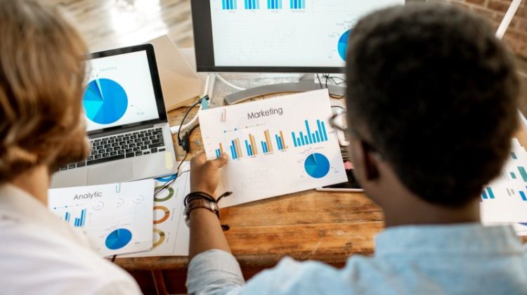 Coworkers working together with marketing analytics