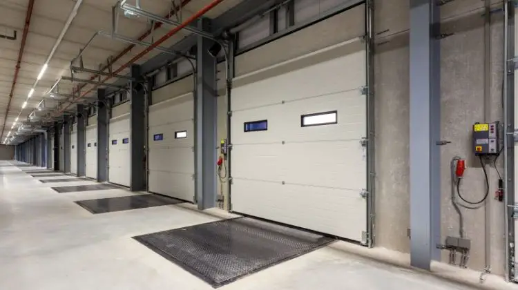 Inside of a warehouse with a row of loading bays