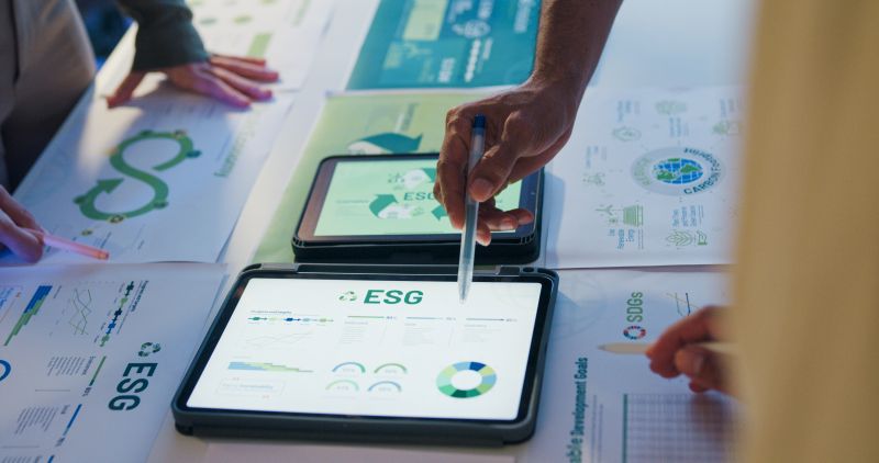 Closeup group Asia businesspeople talk ESG strategies risk management workshop night.