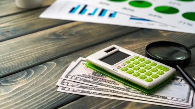Business graphs paper and calculator on table